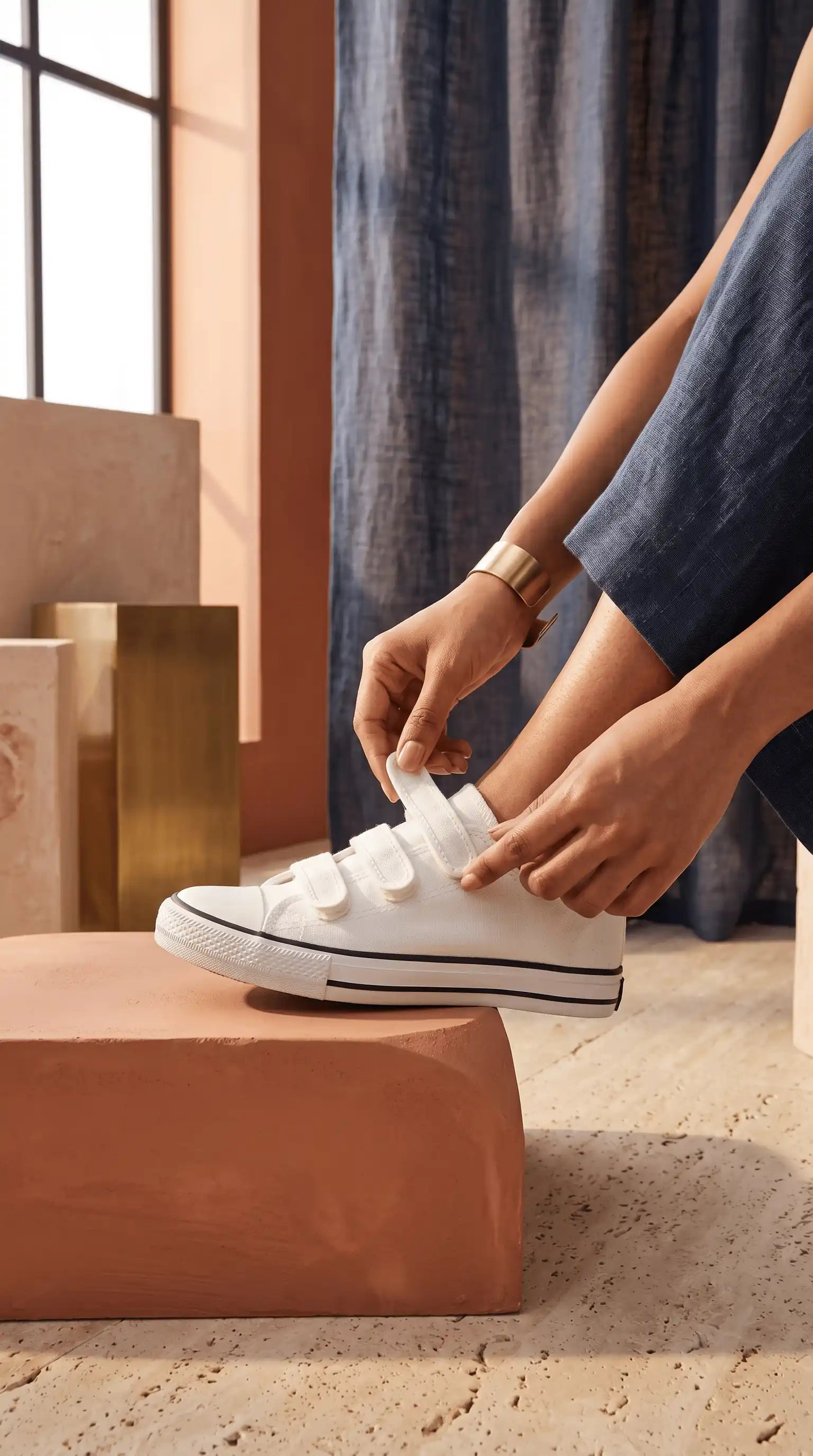 Person tying a white eluxeri canvas on a neutral background