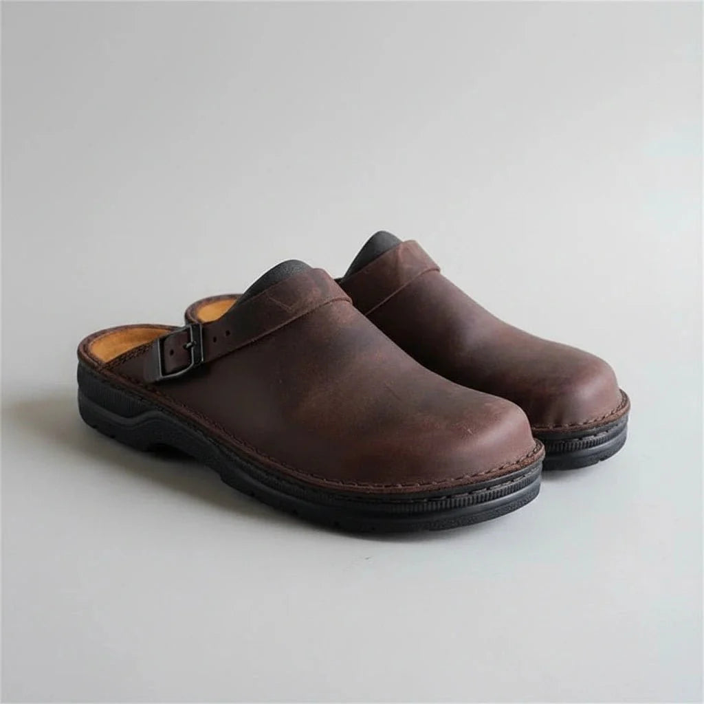 brown eluxeri clogs from the front on a light background