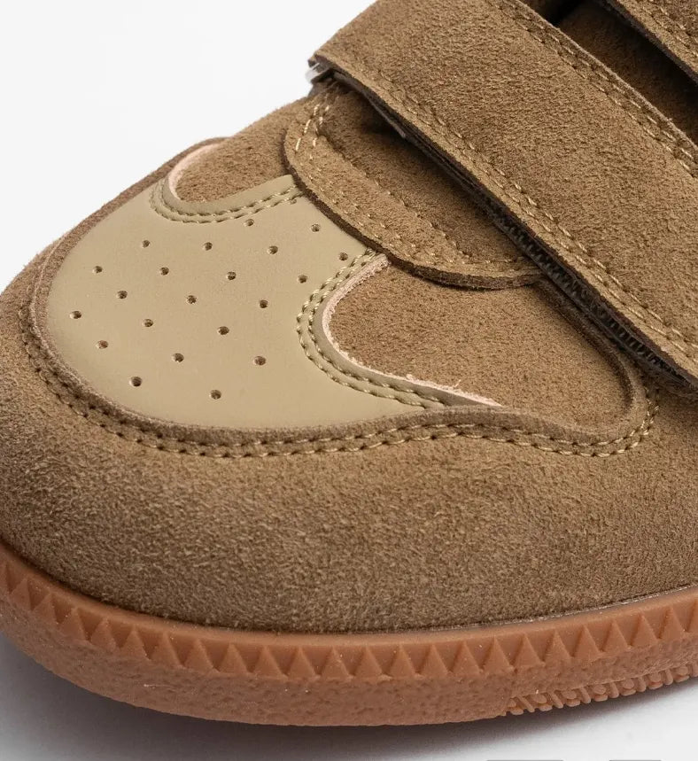 Brown eluxeri easewalks with velcro straps on a light gray background